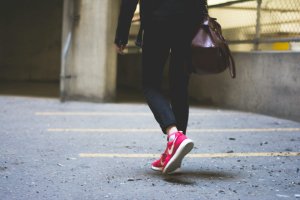 Home 35 Person walking briskly outdoors on a path, illustrating walking for weight loss