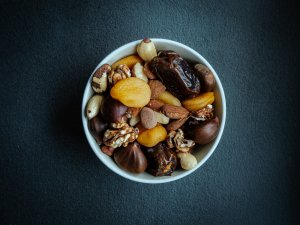 Home 34 White bowl of nuts on a table, a filling snack among foods that keep you full