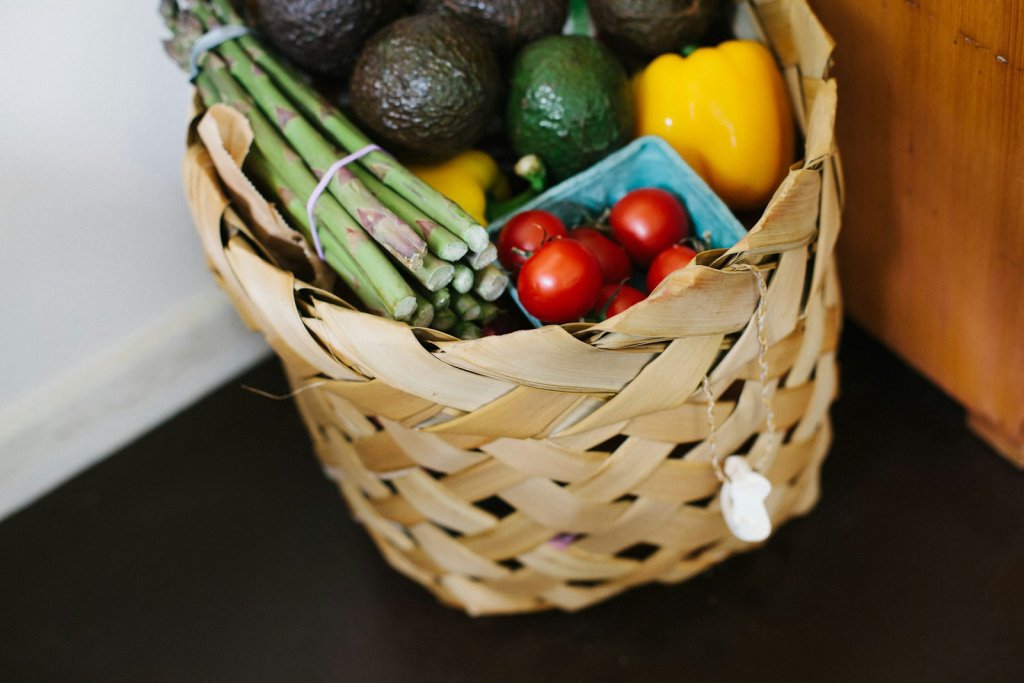 Wicker basket of fresh produce for healthy grocery shopping