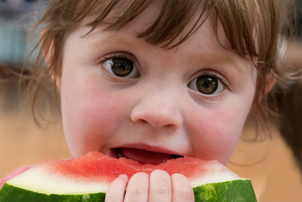 Healthy Snacks for Kids: Easy Ideas Parents Can Use 2 Child eating watermelon, a fresh fruit option among healthy snacks for kids
