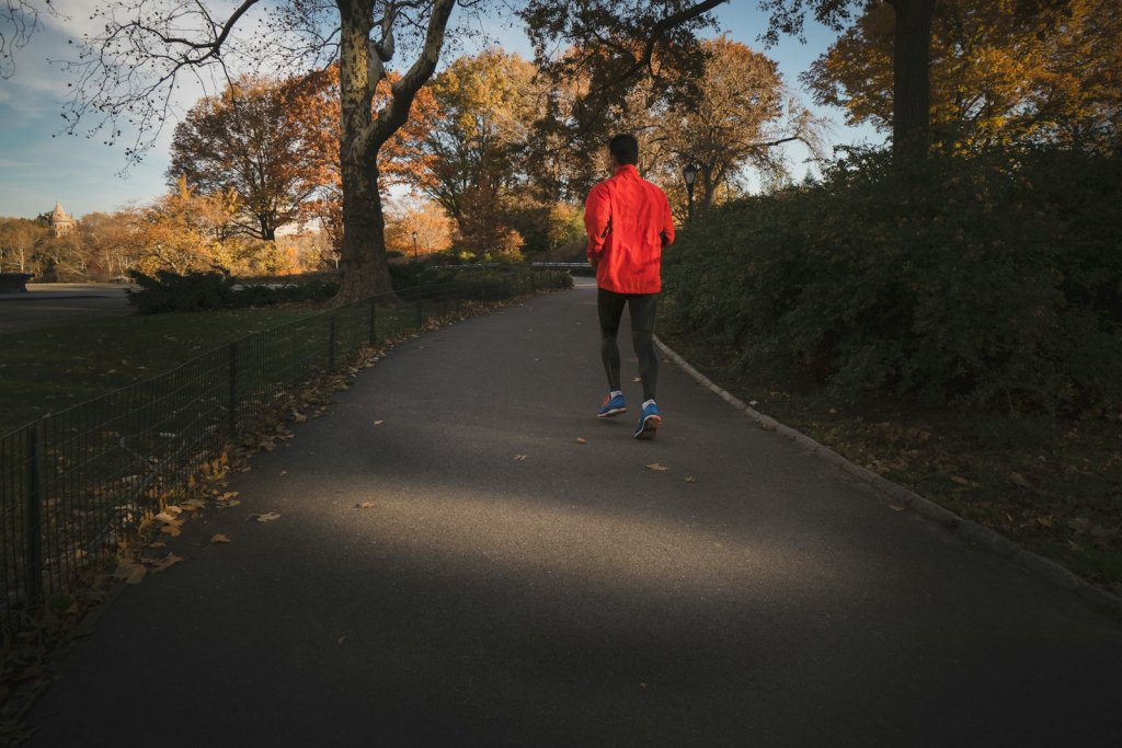 Male Fertility: Everyday Habits That Support Sperm Health 2 Man jogging near a park, an active habit that supports male fertility
