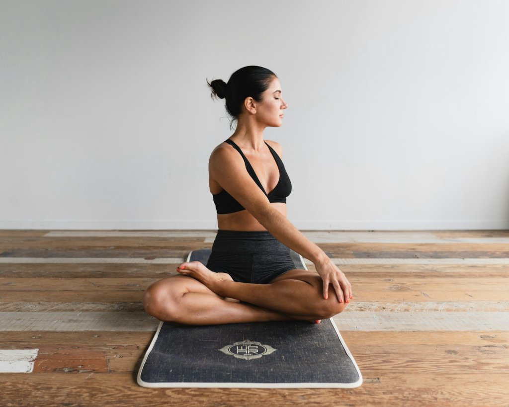 Woman on a mat practicing gentle exercise to strengthen pelvic floor muscles
